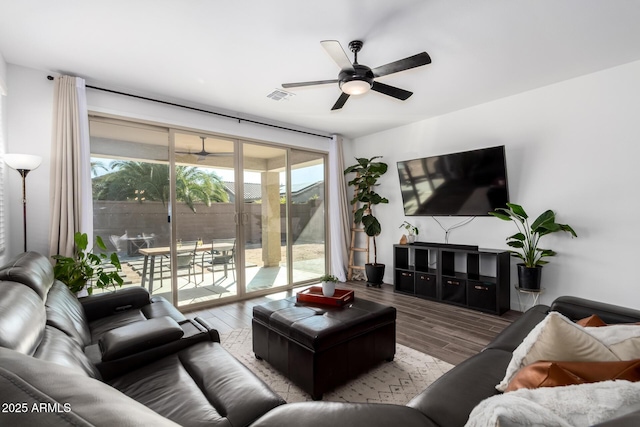 living room with hardwood / wood-style flooring and ceiling fan