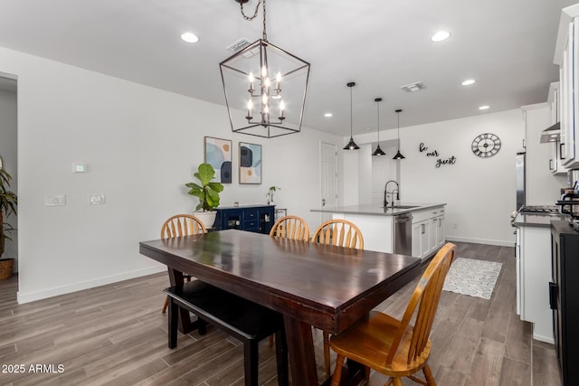 dining space with light hardwood / wood-style floors and sink