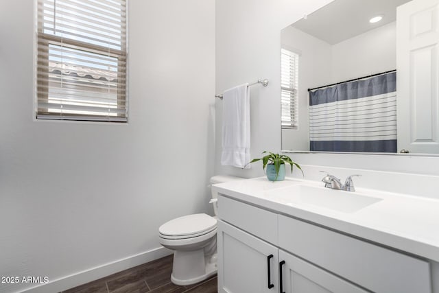 bathroom with vanity, hardwood / wood-style floors, and toilet