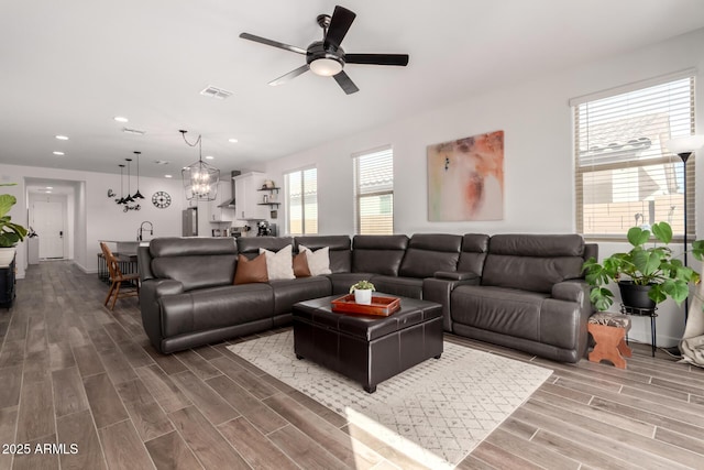 living room featuring ceiling fan and sink