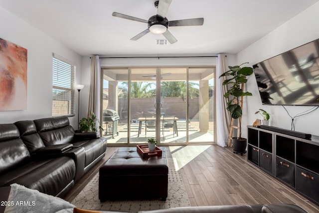 living room with ceiling fan and hardwood / wood-style floors