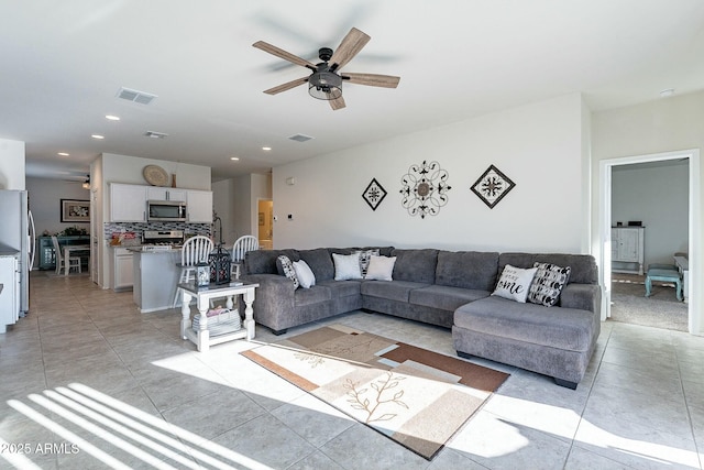 living room featuring ceiling fan and light tile patterned floors