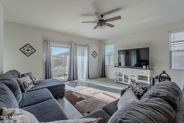 tiled living room with a wealth of natural light and ceiling fan