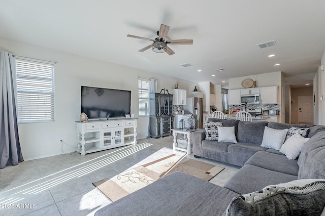 living room featuring ceiling fan and light tile patterned floors