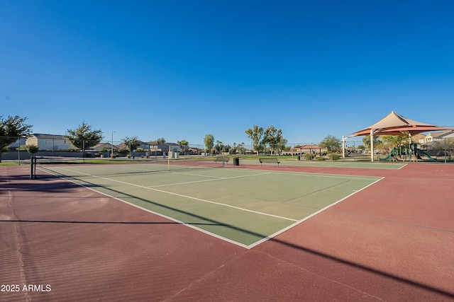 view of tennis court featuring basketball hoop