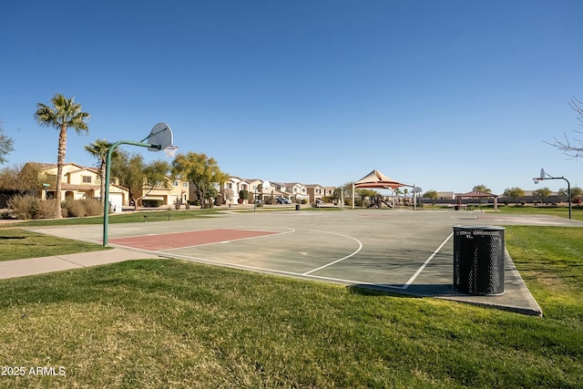 view of sport court featuring a lawn and a gazebo