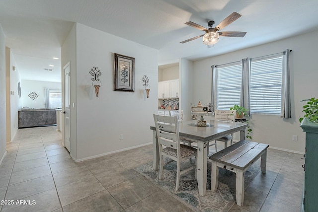 tiled dining space with ceiling fan