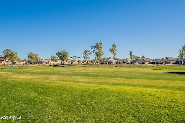 view of property's community featuring a lawn