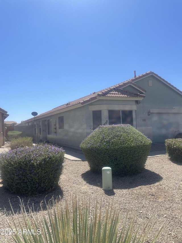 1347 E Vernoa St, San Tan Valley, AZ 85140 - exterior space with stucco siding and a tile roof