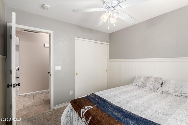 1347 E Vernoa St, San Tan Valley, AZ 85140 - bedroom with a closet, visible vents, carpet, a ceiling fan, and wainscoting