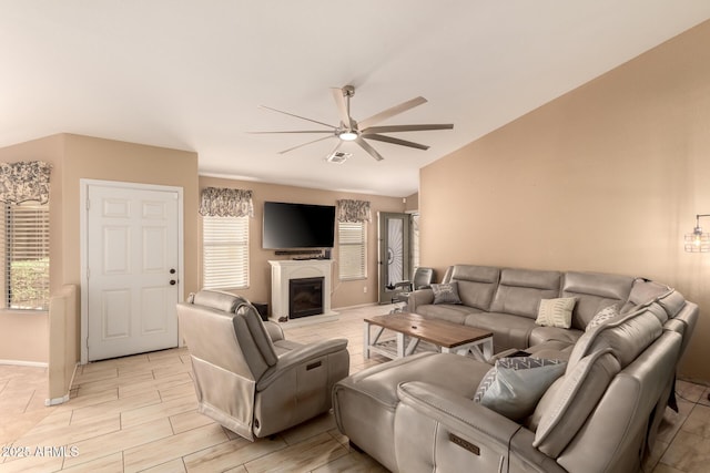 1347 E Vernoa St, San Tan Valley, AZ 85140 - living room featuring a ceiling fan, a glass covered fireplace, lofted ceiling, wood finish floors, and visible vents