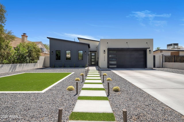 2225 E Whitton Ave E, Phoenix, AZ 85016 - contemporary home with an attached garage, fence, stucco siding, and concrete driveway