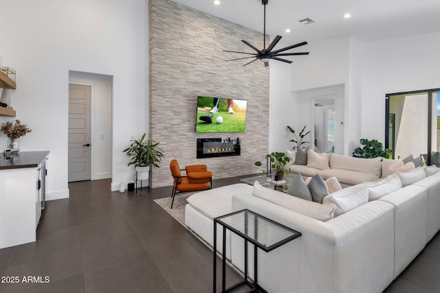 2225 E Whitton Ave E, Phoenix, AZ 85016 - living area featuring a large fireplace, visible vents, a ceiling fan, and a high ceiling