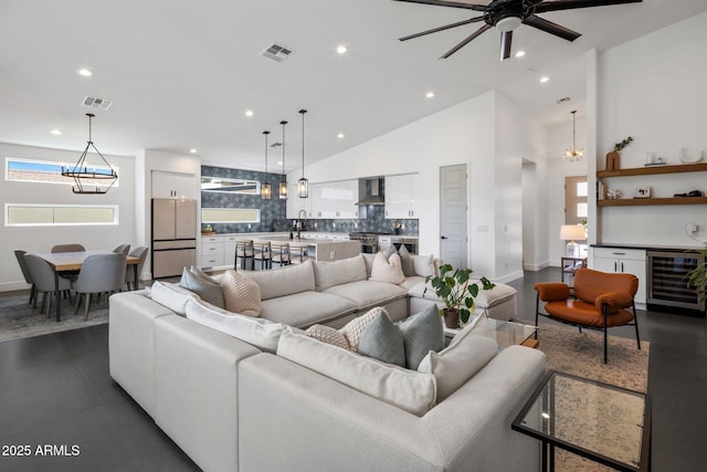 2225 E Whitton Ave E, Phoenix, AZ 85016 - living area featuring ceiling fan with notable chandelier, high vaulted ceiling, beverage cooler, and visible vents