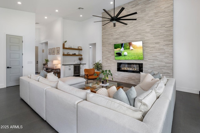 2225 E Whitton Ave E, Phoenix, AZ 85016 - living room featuring a towering ceiling, a fireplace, a ceiling fan, visible vents, and beverage cooler