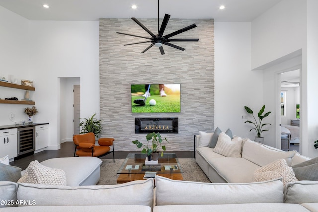 2225 E Whitton Ave E, Phoenix, AZ 85016 - living room with a fireplace, dark wood-style floors, a ceiling fan, a dry bar, and wine cooler