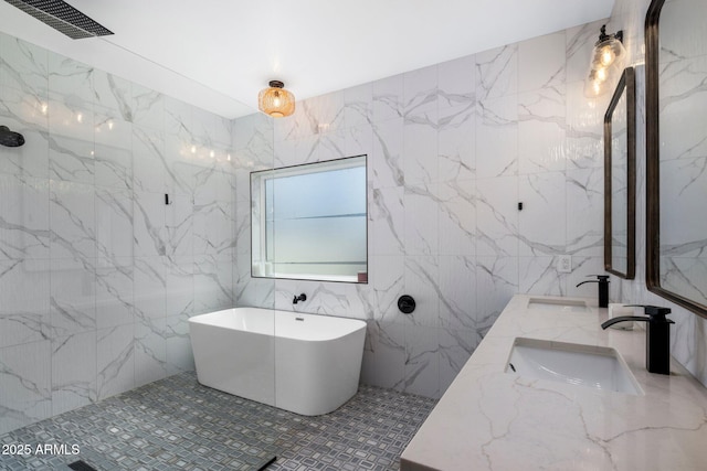 2225 E Whitton Ave E, Phoenix, AZ 85016 - bathroom with a freestanding tub, double vanity, visible vents, and a sink