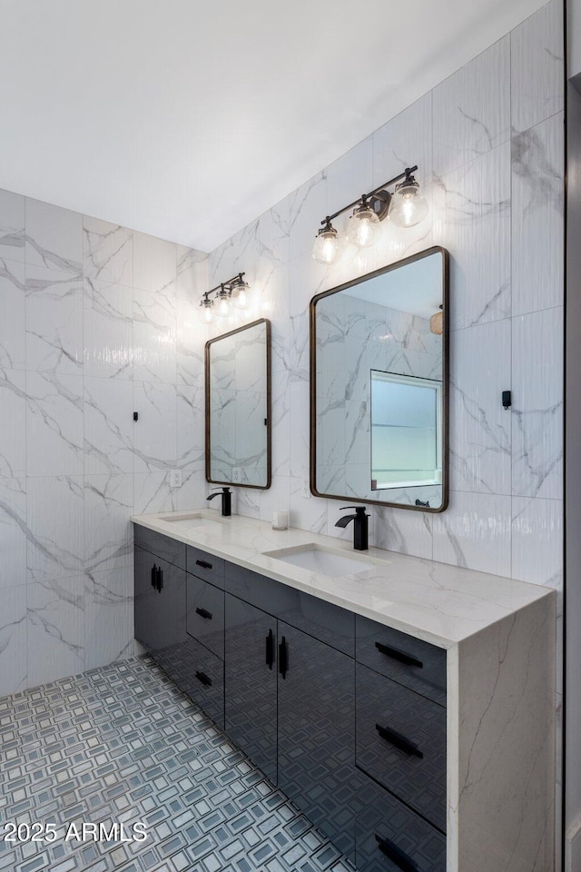 2225 E Whitton Ave E, Phoenix, AZ 85016 - bathroom with a sink, tile walls, double vanity, and decorative backsplash