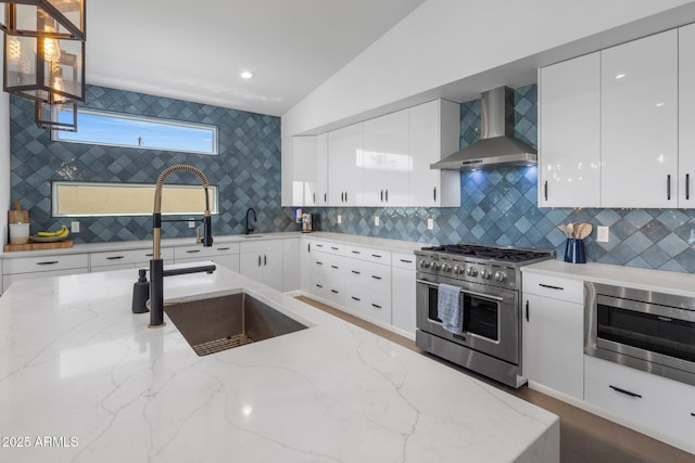 2225 E Whitton Ave E, Phoenix, AZ 85016 - kitchen with wall chimney exhaust hood, modern cabinets, white cabinetry, and appliances with stainless steel finishes