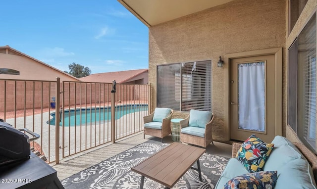 view of patio / terrace with fence, a fenced in pool, and outdoor lounge area