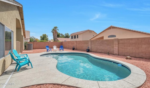 view of swimming pool featuring a patio area, a fenced backyard, a fenced in pool, and central AC