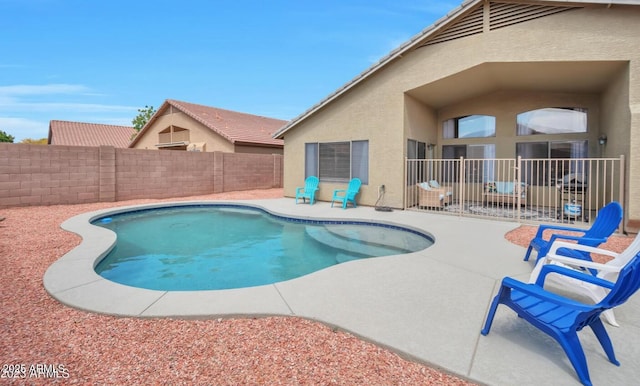 view of swimming pool featuring a fenced backyard, a patio, and a fenced in pool