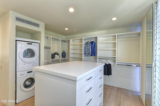4411 N 40th St N Unit 37, Phoenix, AZ 85018 - walk in closet with stacked washing machine and dryer and light wood-type flooring