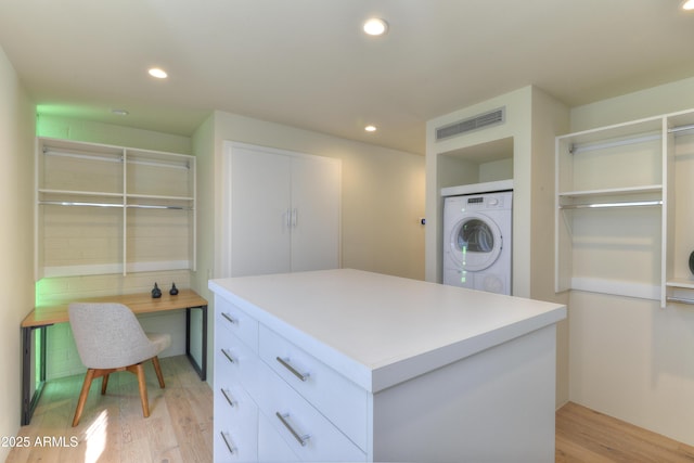 4411 N 40th St N Unit 37, Phoenix, AZ 85018 - walk in closet with stacked washing machine and dryer and light wood-style floors