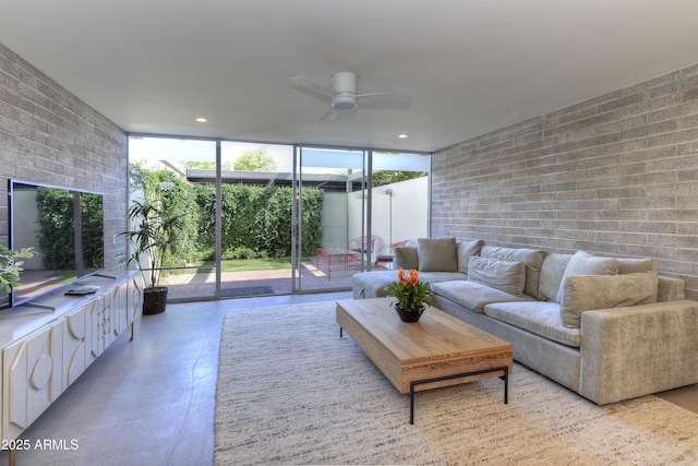 4411 N 40th St N Unit 37, Phoenix, AZ 85018 - living room with a ceiling fan, concrete flooring, and a wall of windows
