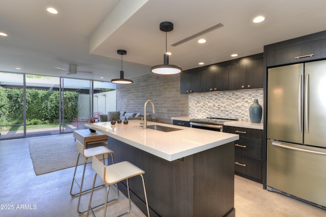4411 N 40th St N Unit 37, Phoenix, AZ 85018 - kitchen with stainless steel appliances, a sink, decorative backsplash, light countertops, and a kitchen breakfast bar