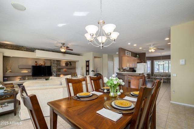 dining space featuring light tile patterned flooring, ceiling fan with notable chandelier, and built in shelves