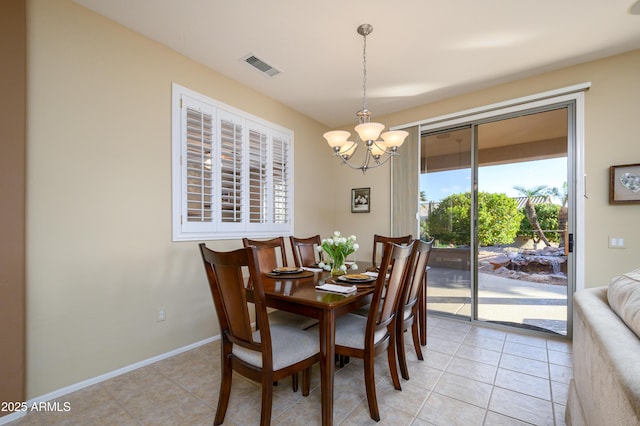 dining space featuring a notable chandelier and light tile patterned floors