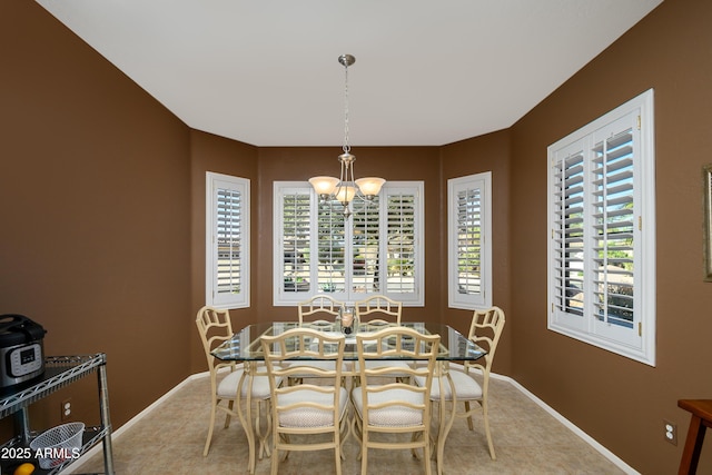 dining area with an inviting chandelier