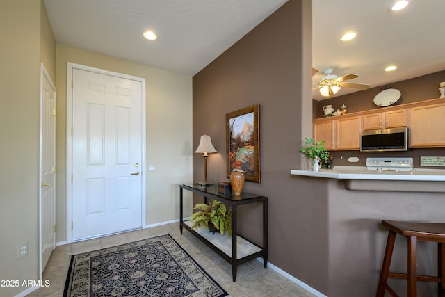 tiled foyer entrance featuring ceiling fan