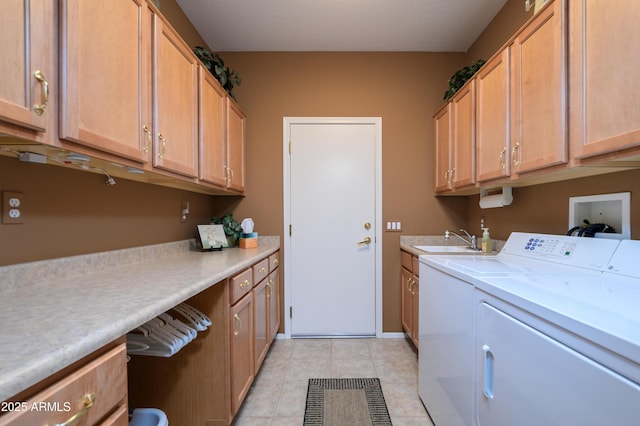 laundry area featuring cabinets, washer and dryer, sink, and light tile patterned floors