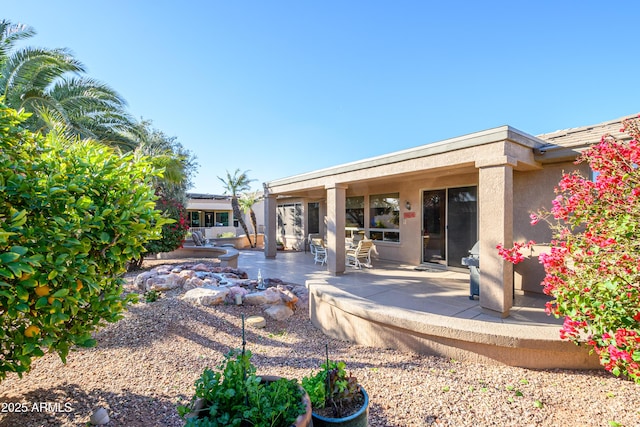 rear view of property featuring a patio area