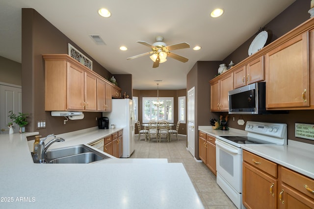 kitchen featuring ceiling fan, sink, white appliances, and decorative light fixtures