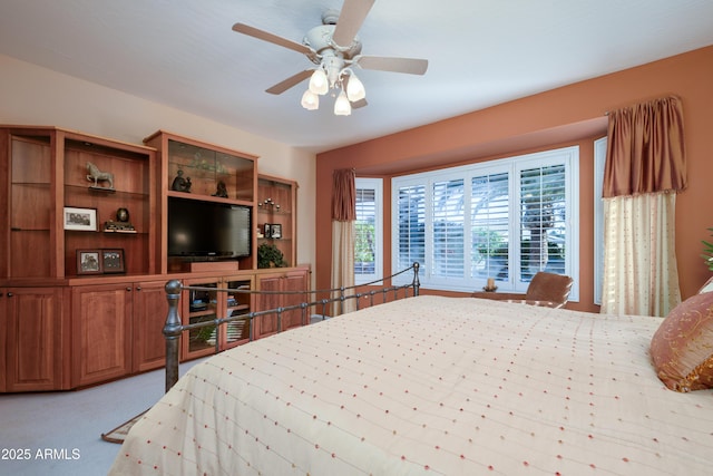 bedroom with light carpet and ceiling fan