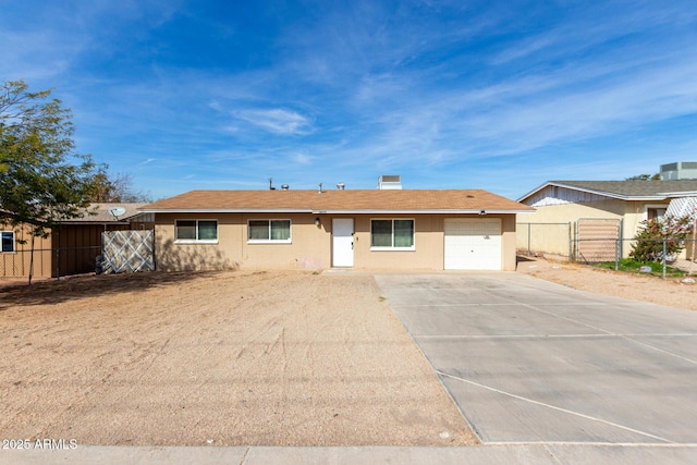 ranch-style house featuring a garage, driveway, a chimney, and fence