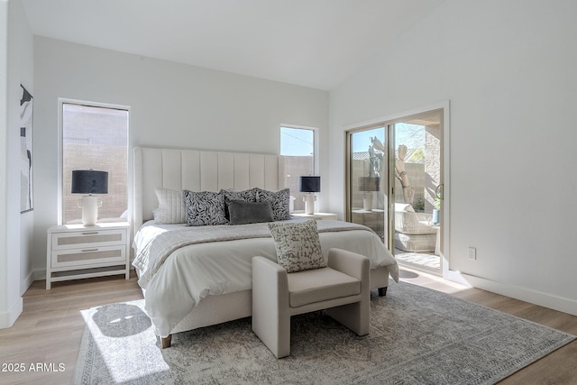 bedroom with high vaulted ceiling, access to outside, light wood-style flooring, and baseboards