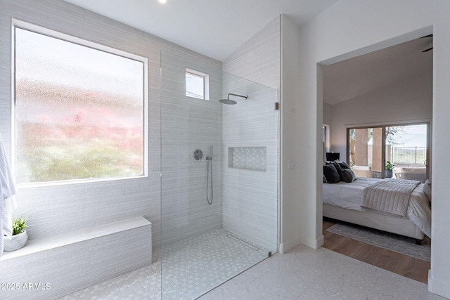 ensuite bathroom featuring vaulted ceiling, walk in shower, and ensuite bath