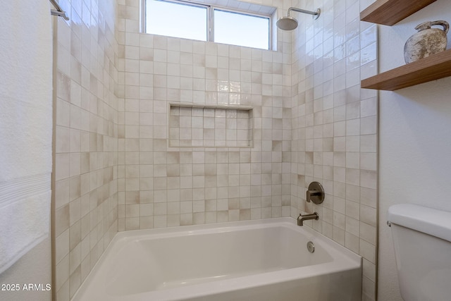 bathroom featuring bathtub / shower combination and toilet