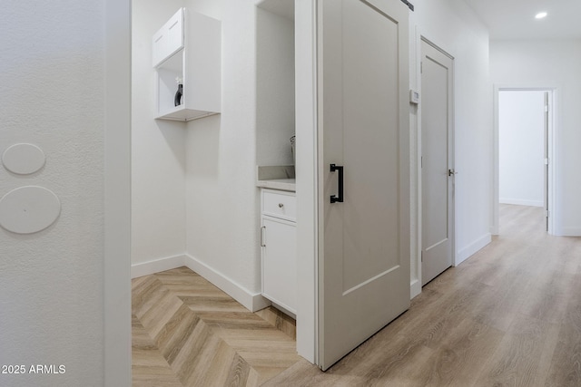 corridor with recessed lighting, parquet floors, and baseboards