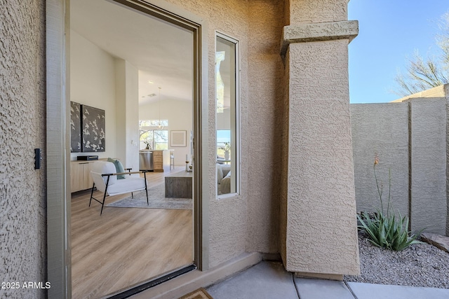 entrance to property with stucco siding