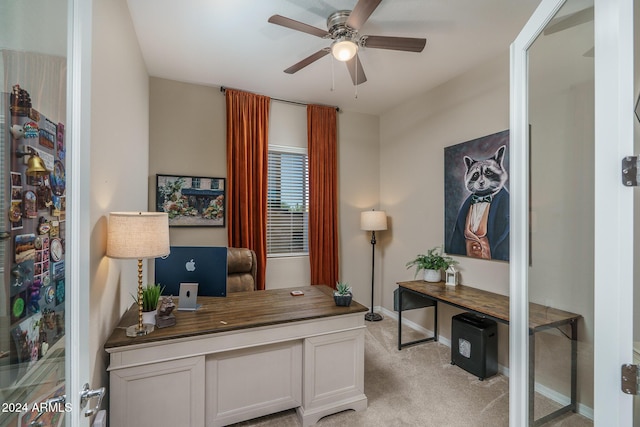 office area featuring light carpet and ceiling fan