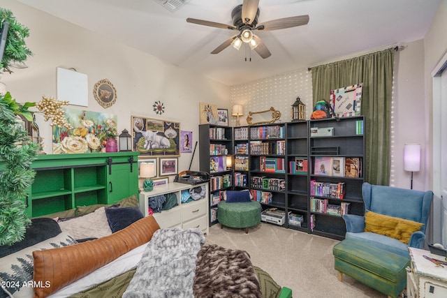 living area with carpet flooring and ceiling fan