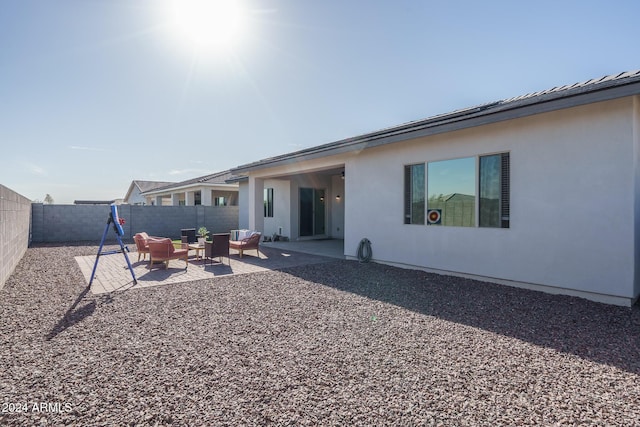 back of property featuring an outdoor hangout area and a patio