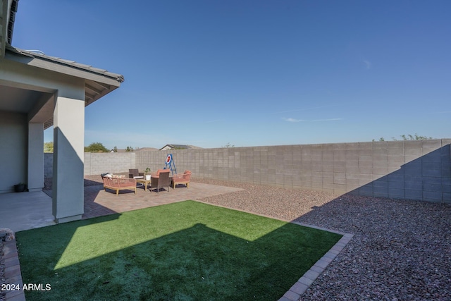 view of yard with an outdoor living space and a patio