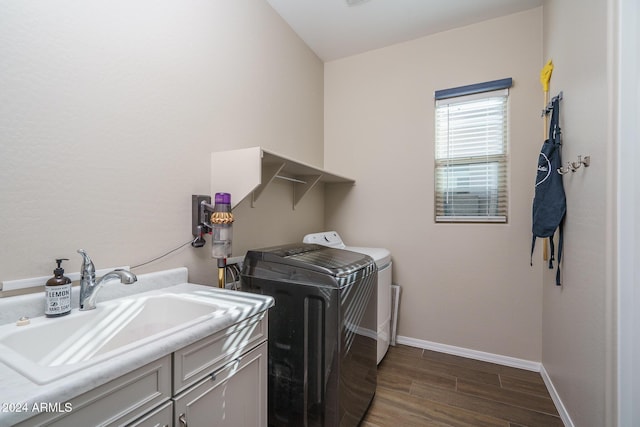 laundry area featuring cabinets, sink, and washer and dryer