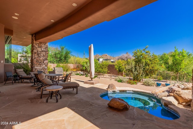 view of pool featuring an in ground hot tub and a patio area